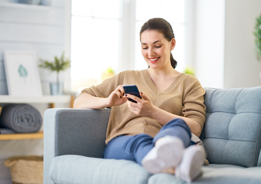 A smiling parent easily creating a personalized digital gift on their laptop at home.