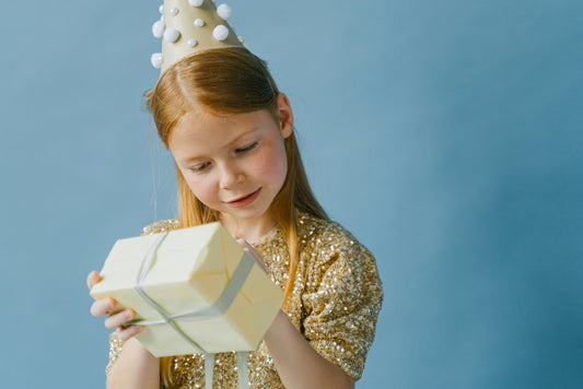 A child looking excited and surprised by a unique gift, representing a gift guide for kids.