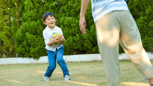 A child happily playing with beautiful, sustainable wooden toys in a bright, natural setting.