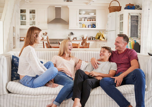 A parent and grandparent having a positive, smiling conversation about family gift-giving